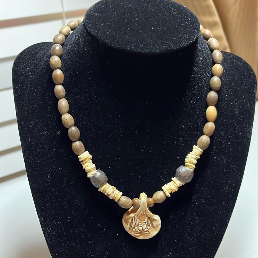 Handcrafted wood and stone bead necklace with carved pendant